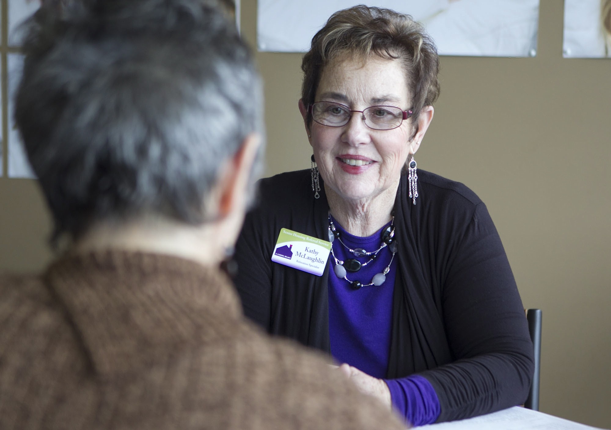 Kathy McLaughlin meets with a client at A Caring Heart Housing Referral Service on Tuesday in Vancouver.