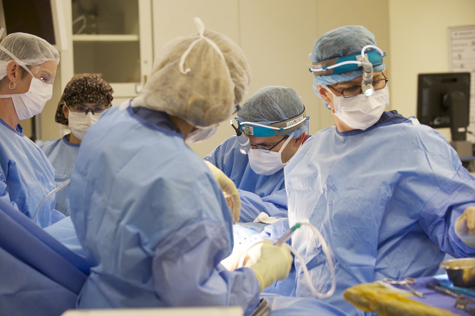 Dr. Allen Gabriel, second from right, injects Botox into the pectoral muscle of a patient during breast reconstruction surgery Sept. 2 at PeaceHealth Southwest Medical Center.