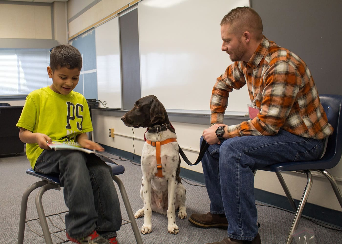 Ridgewood: Union Ridge Elementary School first-grader Rick Alanis reads to therapy dog Bruno and Jason Winters, who visited the school each week with the dog through Columbia River Pet Partners.
