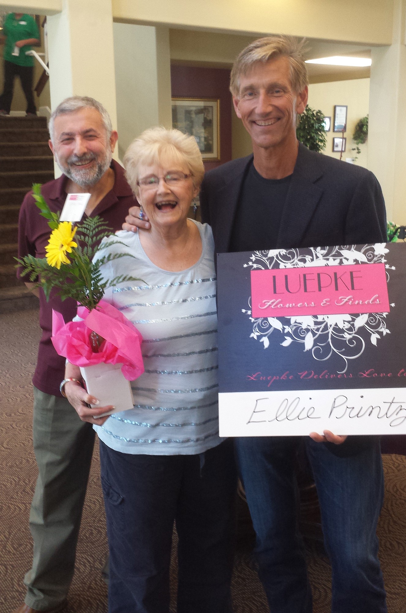 Hazel Dell South: Ellie Printz, center, with her son Randy Printz, right, was the first honoree from Luepke Flowers' &quot;Because We Care&quot; program, where each month store owner Bruno Amicci, left, will bring a bouquet of flowers to a resident of an assisted living community.