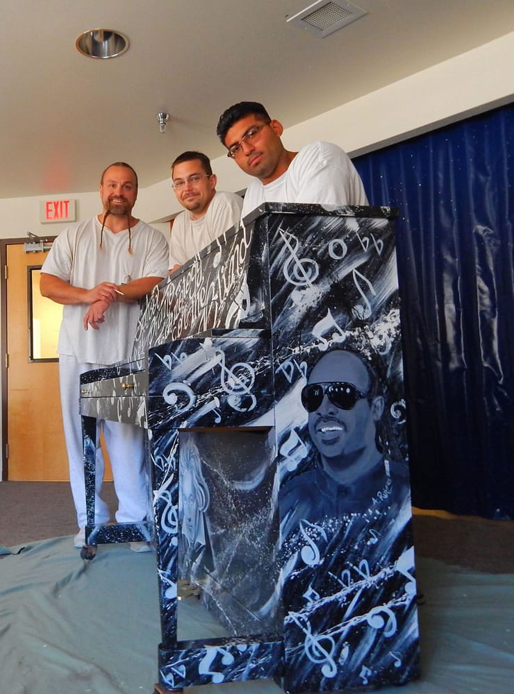 Larch Corrections Center art club members Melville Tangen, Bryan McGee and Antonio Ruiz painted this conspicuously cosmic piano.