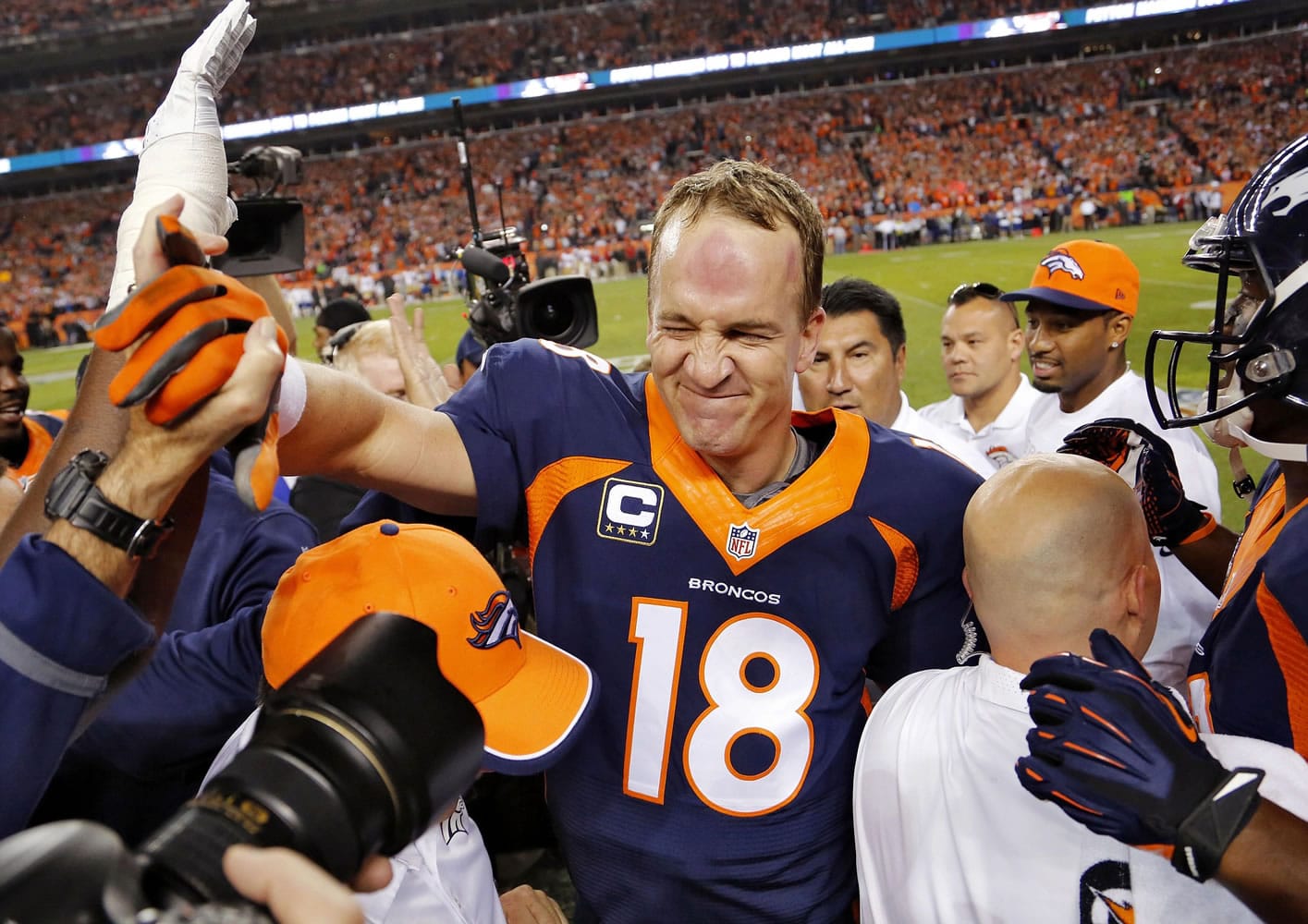 Denver Broncos quarterback Peyton Manning (18) celebrates his 509th career touchdown pass with teammates during the first half against the San Francisco 49ers on Sunday, Oct. 19, 2014, in Denver.