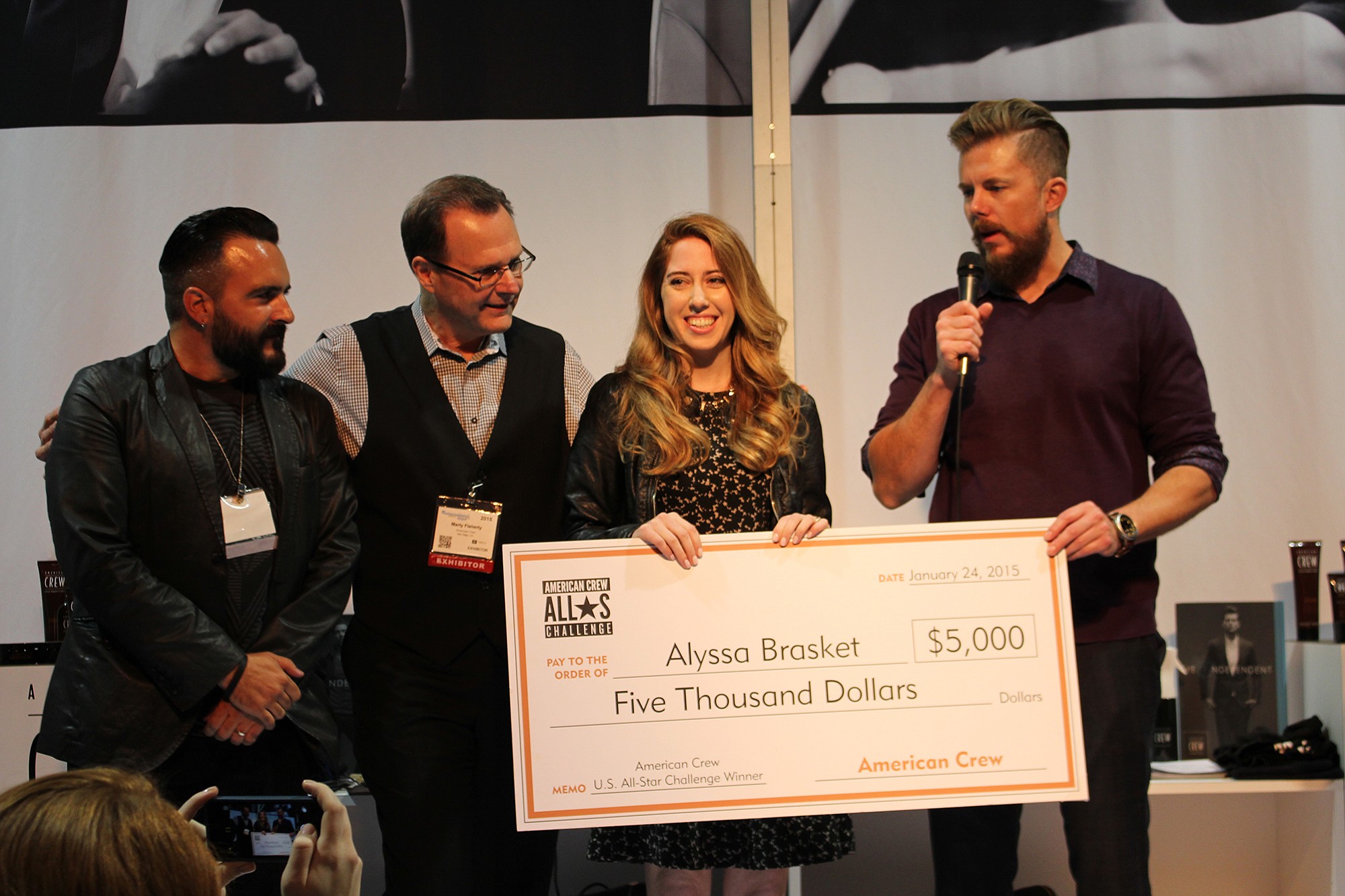 Hairstylist Alyssa Brasket, second from right, of Camas is flanked by Sergi Bancells of Estetica USA, from left, Martin Flaherty of Revlon Professional Brands and Kevin Grieve of American Crew as she receives an award after winning the American Crew U.S. All-Star Challenge on Jan. 25 in Long Beach, Calif.