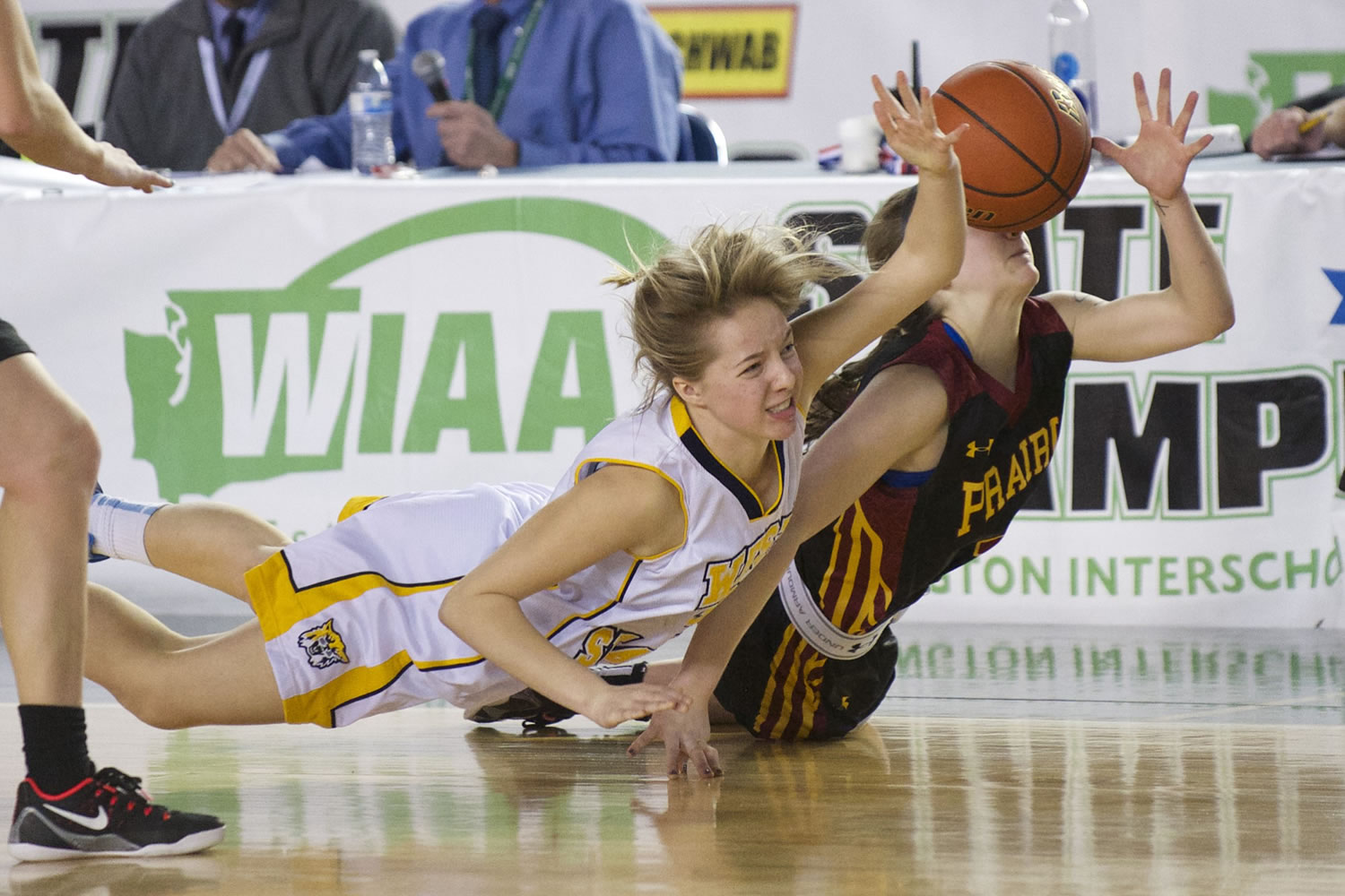 Jozie Tangeman , right, fights for a loose ball with West Seattle's IzzyTurk as Prairie loses to West Seattle 54-45 at the 2015 WIAA Hardwood Classic 3A Girls tournament at the Tacoma Dome, Friday, March 6, 2015.