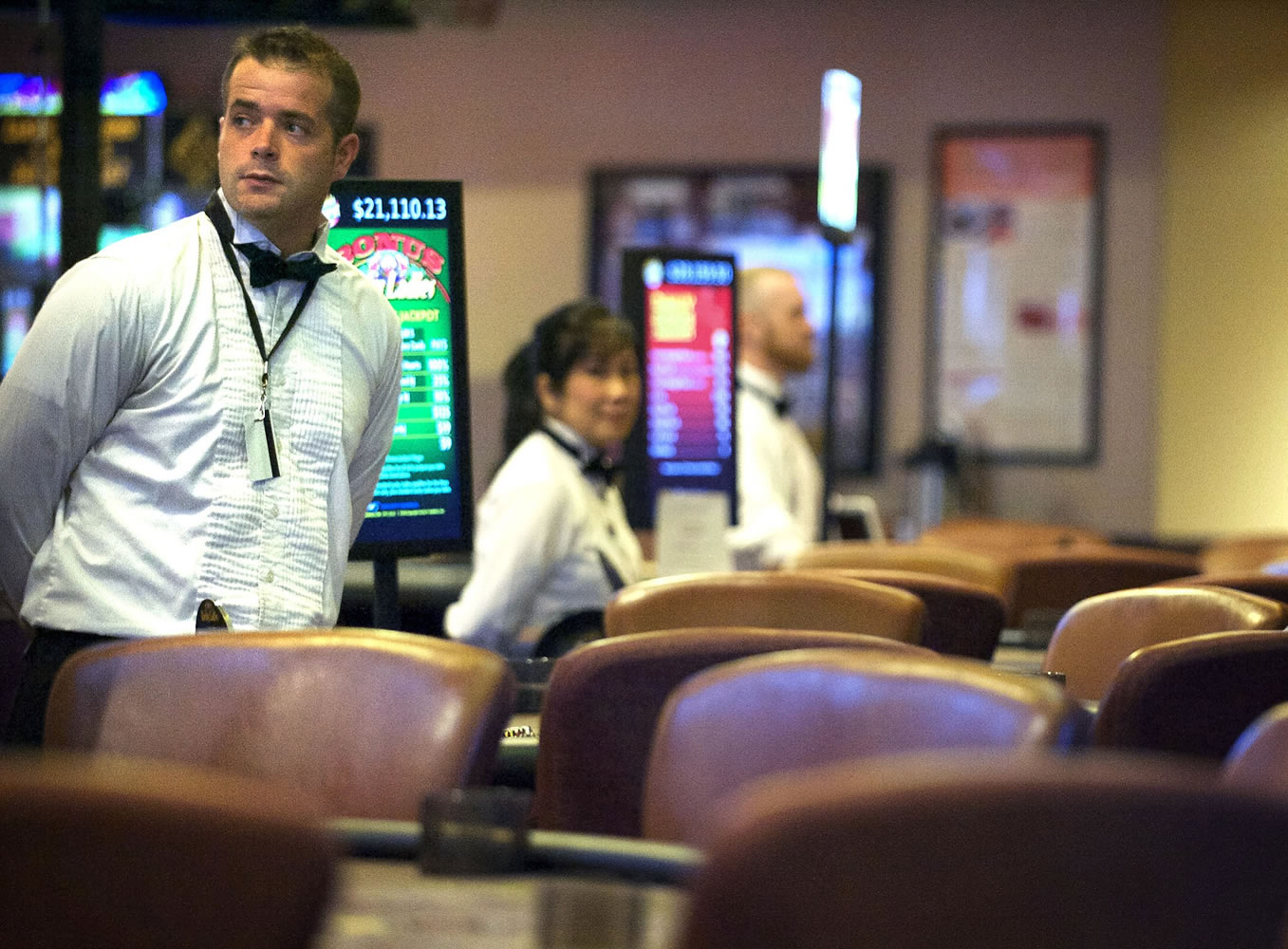 Zachary Kaufman/The Columbian
Blackjack dealer Josh Skucas, 33, stands at an empty table at the Oak Tree's casino in Woodland on Tuesday. Card rooms have struggled to earn money locally, impacting the cities that collect taxes from them.