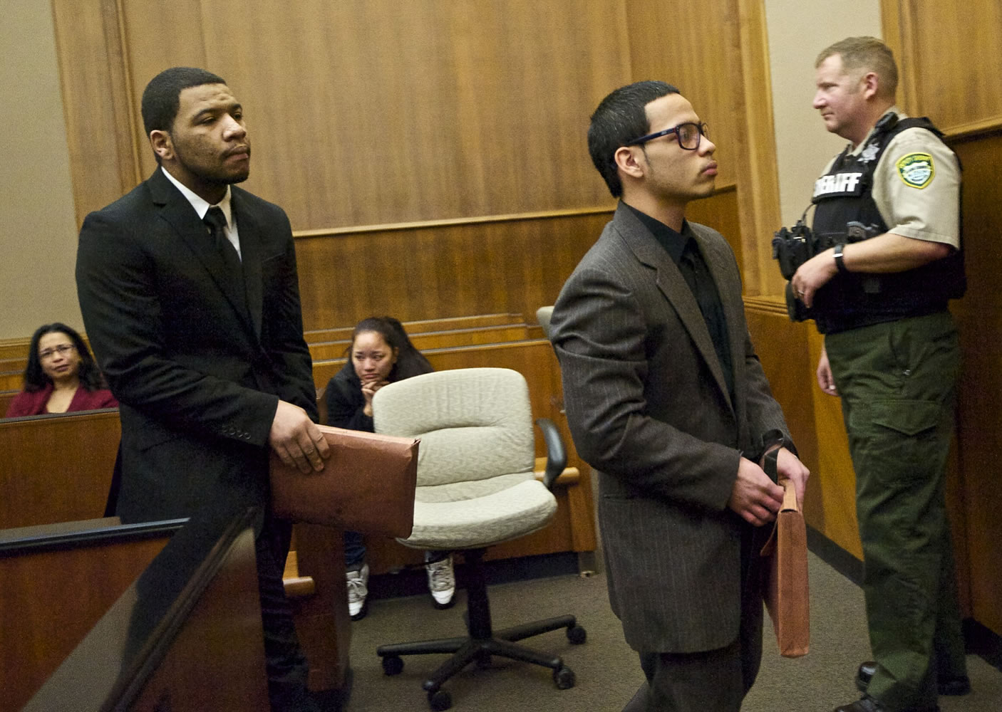 Co-defendants Brandon English, left, and Calvin Quichocho are escorted out of Clark County Superior Court Judge Barbara Johnson's courtroom Thursday after a jury found them guilty of multiple crimes connected with a home-invasion robbery in Vancouver in December.