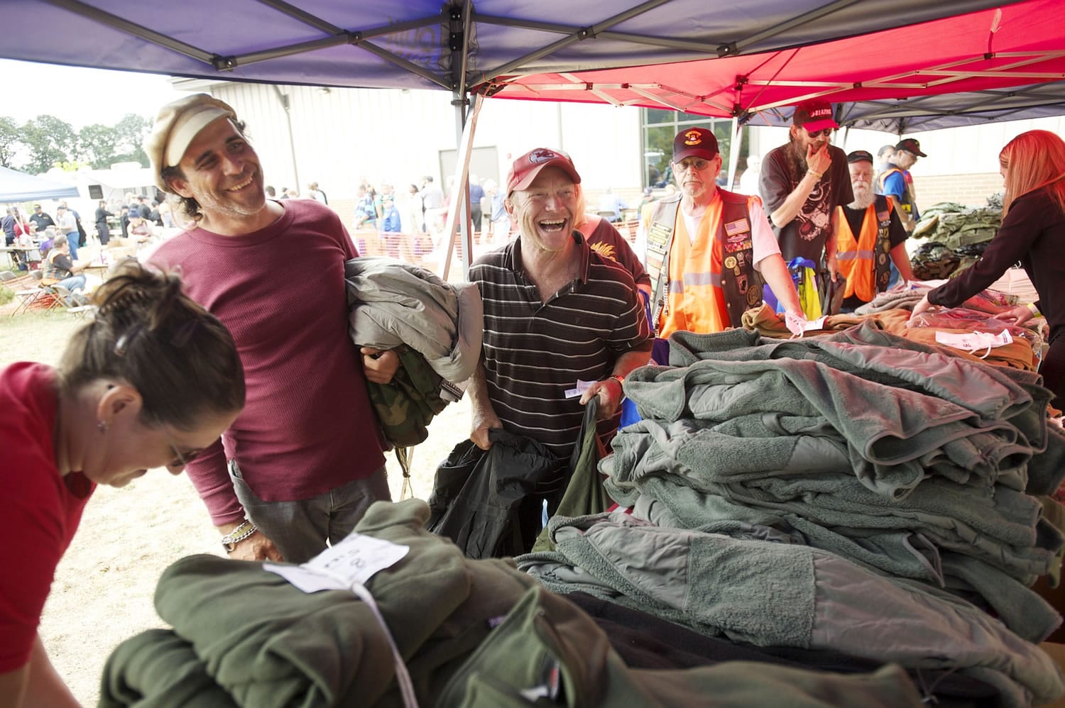 Photos by Steven Lane/The Columbian
U.S. Army veteran Paul Rodriguez-Navarro, left, and Navy veteran Dave Sommer pick up military surplus items Wednesday at the annual Veterans Stand-Down event at the Armed Forces Reserve Center.