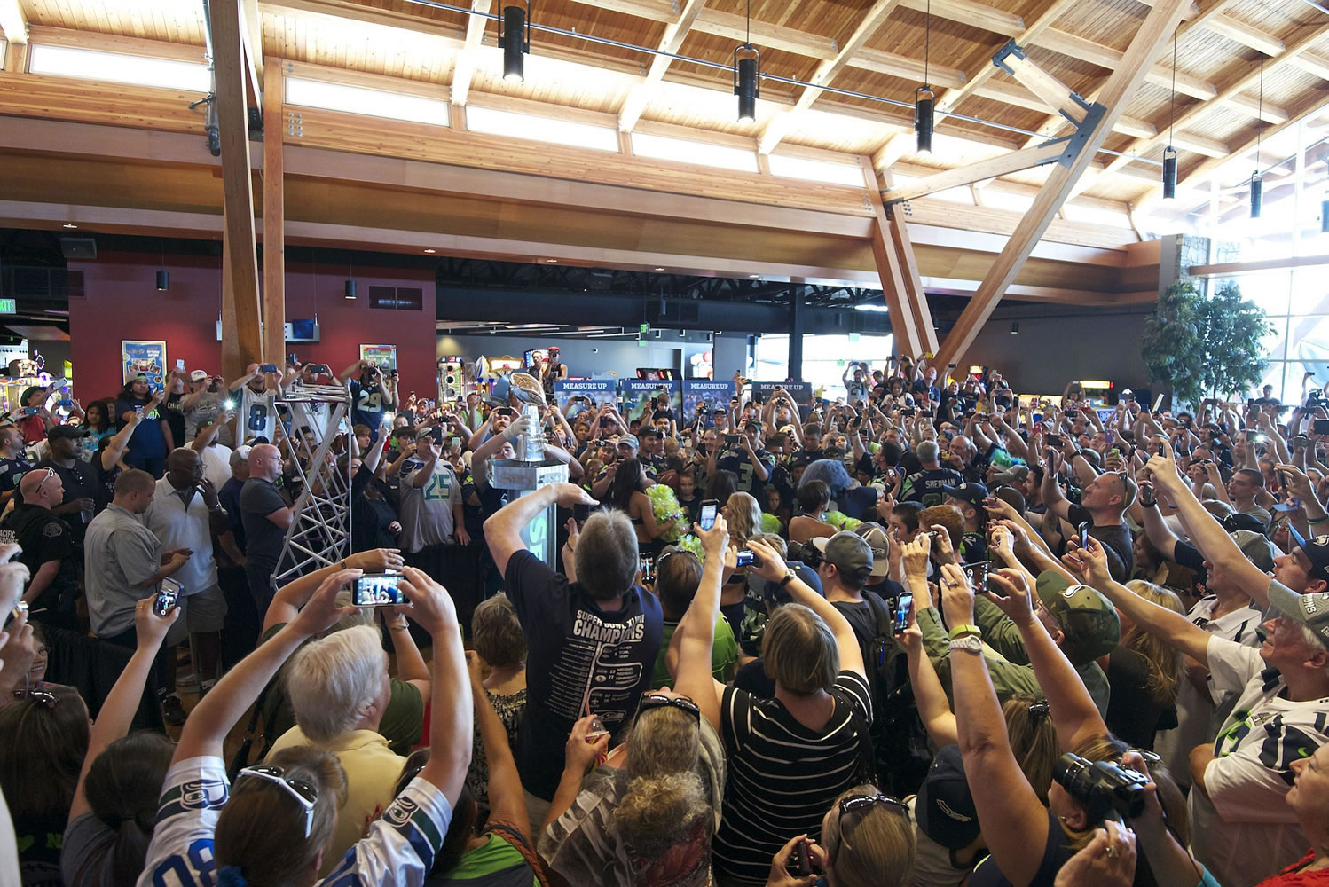 Hundreds of Seattle Seahawks fans snap pictures as the Vince Lombardi Trophy is revealed and placed on a pedestal during a 12 Tour event Friday at Big Al's in east Vancouver.