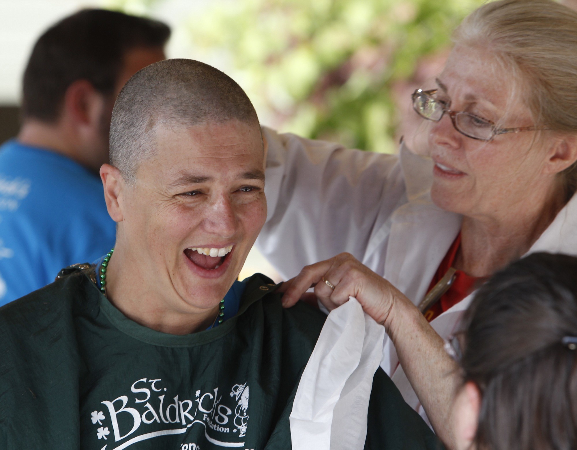 Ada Dellay, a teacher at Cascade Middle school, has her head shaved at a cancer research fundraiser for St. Baldrick's Foundation Friday at The Quarry Senior Living.