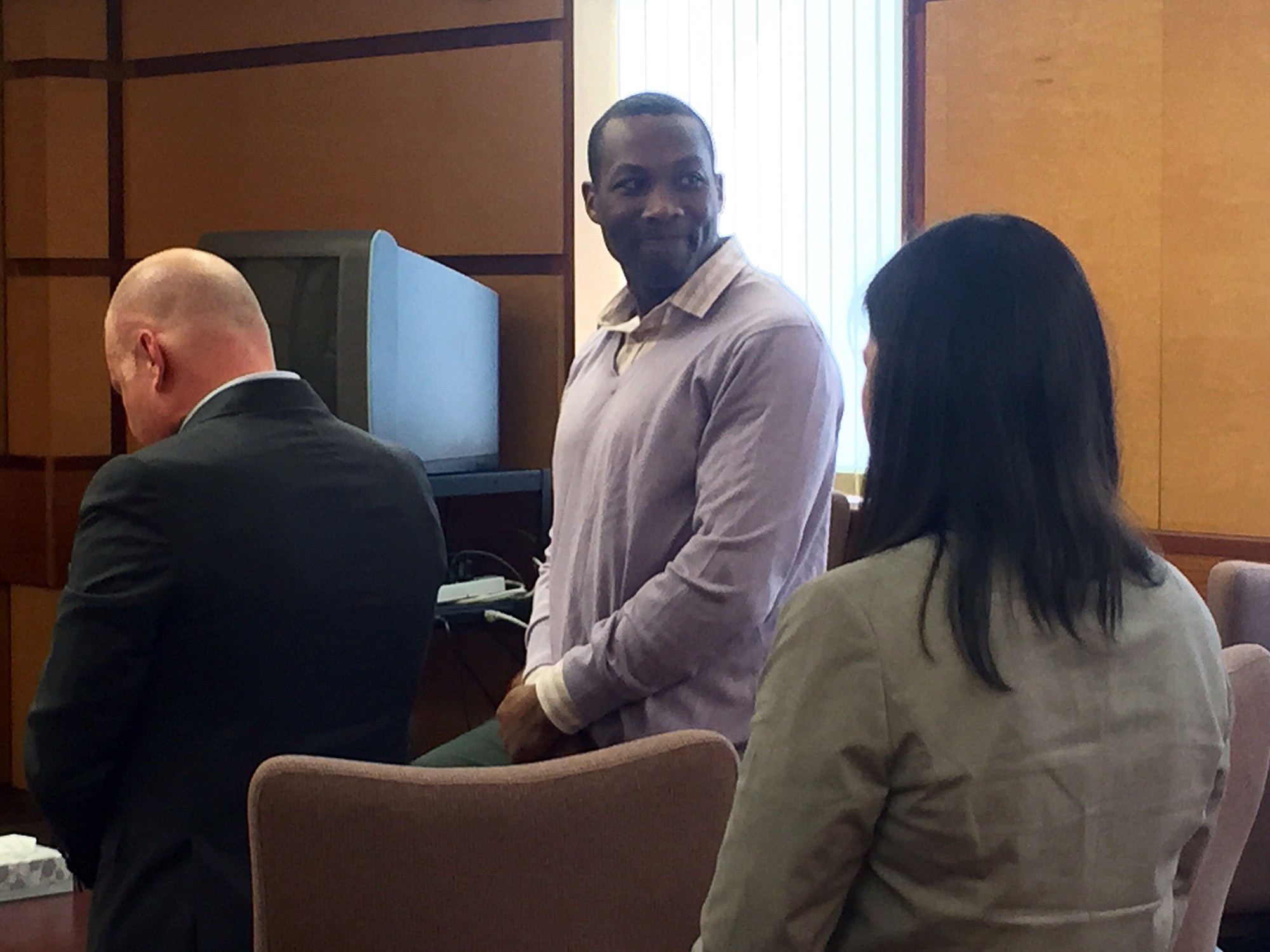 Christopher Warren turns and smiles at his family in Judge Robert Lewis' courtroom after a Clark County Superior Court jury found him not guilty of first-degree child rape.