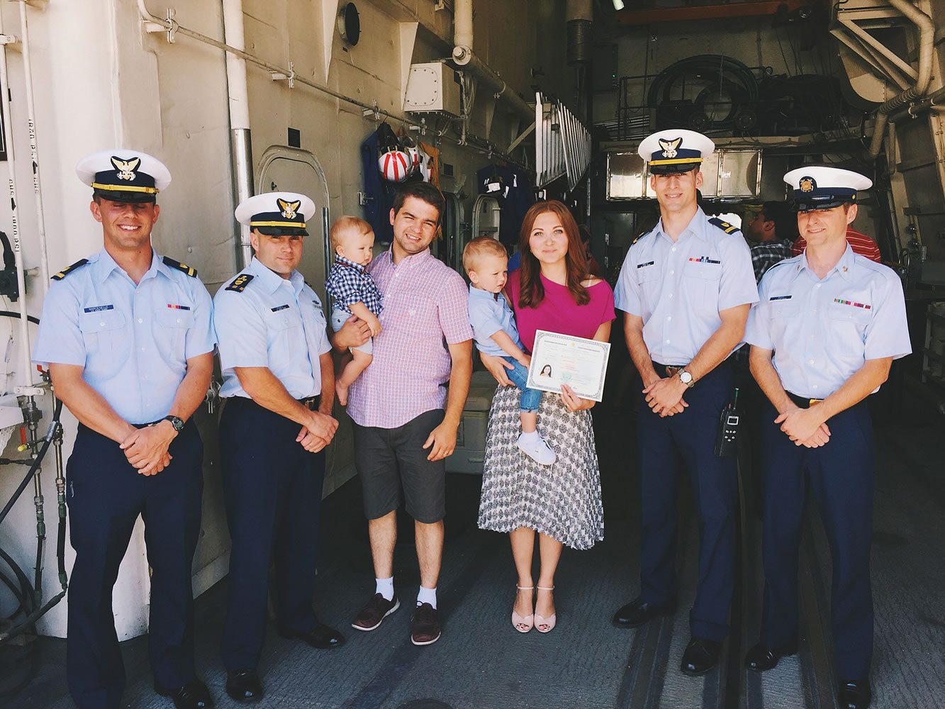 Zhanna Zakharov, center, attends a naturalization ceremony with her husband and two children on June 5 on the flight deck of the USCGC Waesche, where she was sworn in as a citizen after moving to America from Russia in 2009.