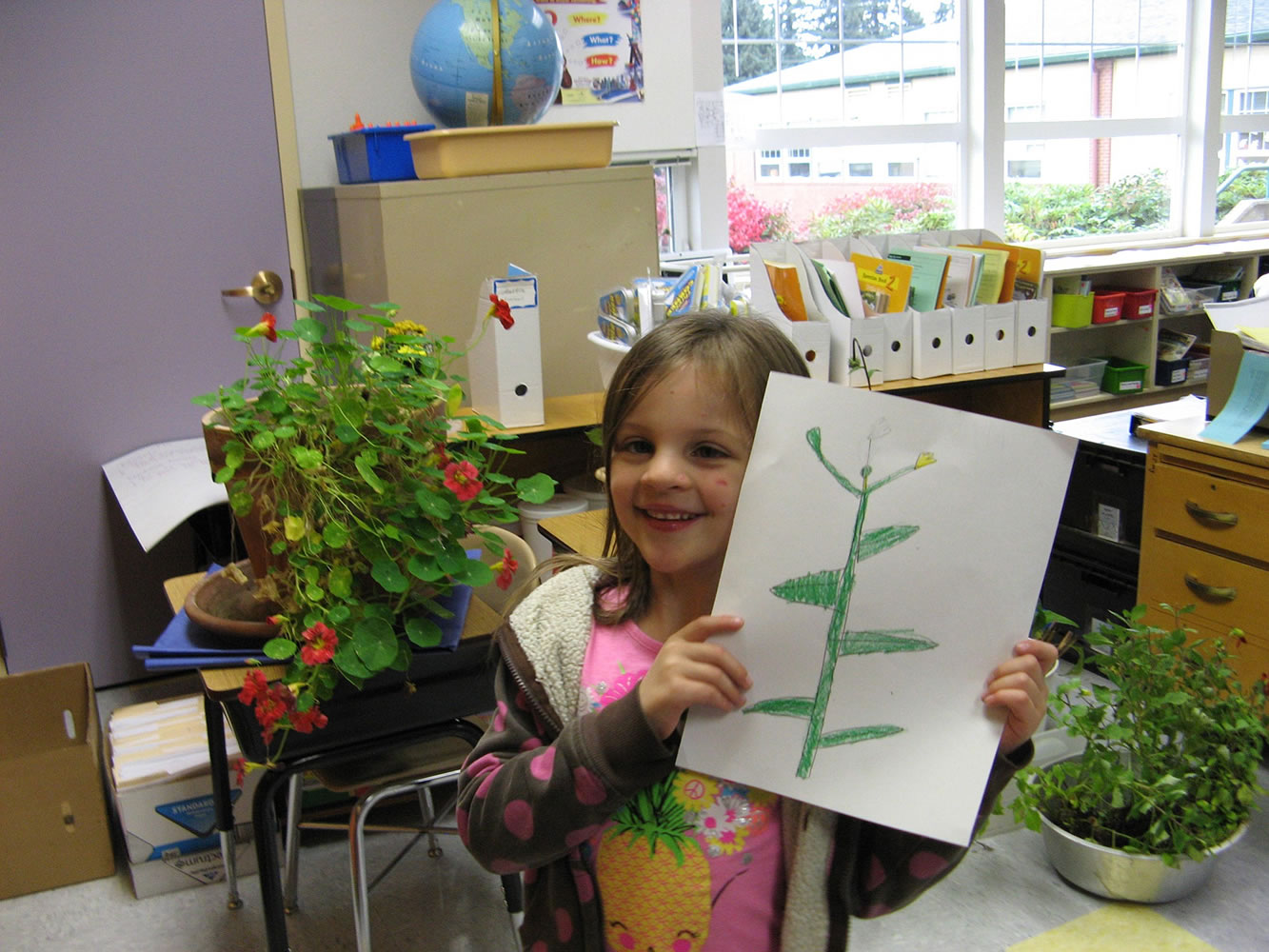 Washougal: Hathaway Elementary School second-grader Mya Peterson holds her drawing of a plant during a recent botany lesson that bridged studies of science and art.