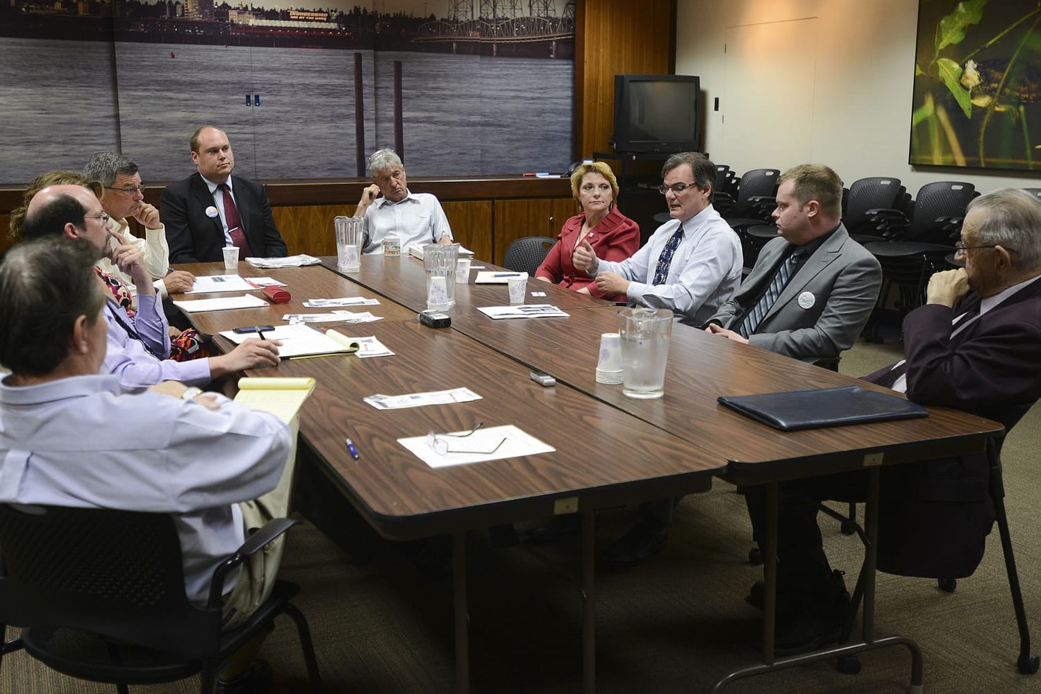 Six of seven candidates for Port of Vancouver commissioner fielded questions Monday from The Columbian's editorial board, who sit at the left of the table. Clockwise from the head of the table are: Eric LaBrant, Bob Durgan, Lisa Ross, Peter Harrison, Nick Ande and Bill Hughes.