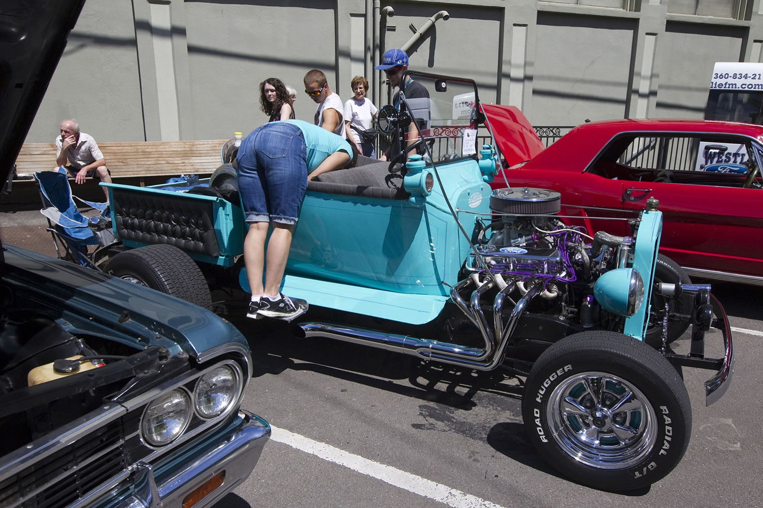 A woman check the seats of a vintage car at the 9th Annual Camas Car Show in downtown Camas, Saturday July 5, 2014.