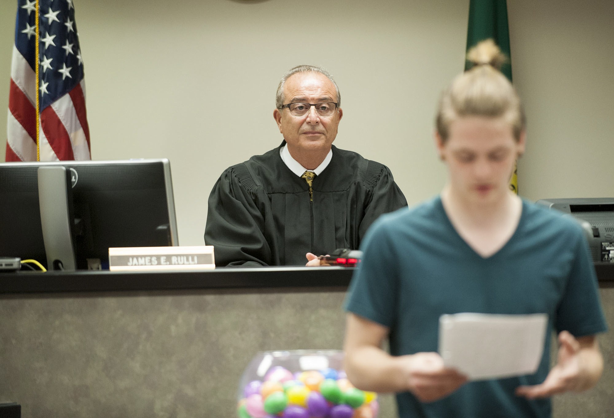 Clark County Superior Court Judge James Rulli listens to Beau Molyneux, 17, read an essay about how he benefited from a juvenile recovery program during a ceremony May 27, 2015, in Vancouver.