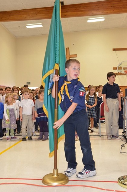 Lincoln: Daniel Forster posts the colors during a Veterans Day assembly Nov.