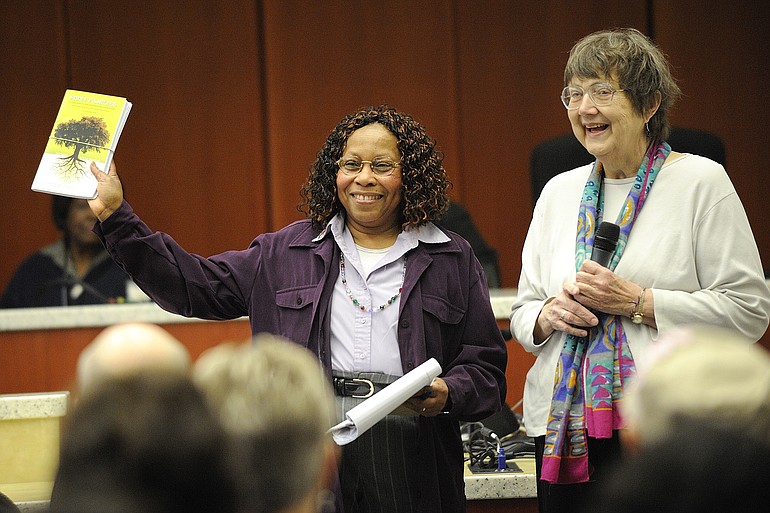 Cornetta Smith, left, shows off a new book Wednesday with author Jane Elder Wulff during a lunchtime presentation at the Clark County Public Service Center.