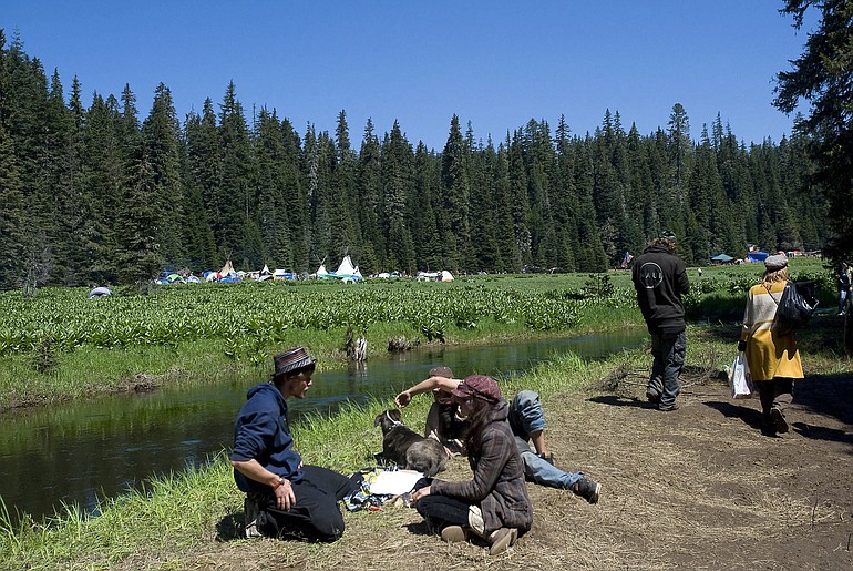 People arrive at the site of the Rainbow Family Gathering in the Gifford Pinchot National Forest on Friday.