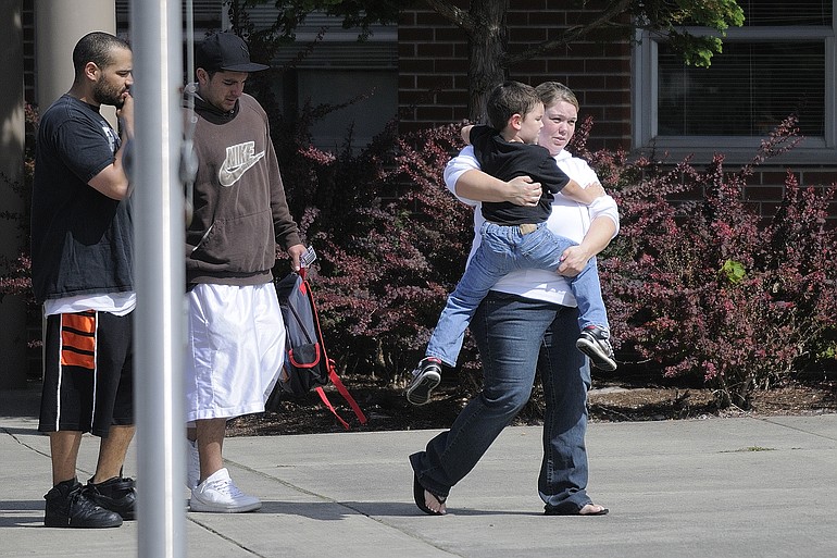 Braiden Gonzalez, 5, is carried out of Walnut Grove Elementary School by his mother after the boy disappeared on his way to school Monday September 13, 2010 in Vancouver, Washington. He was later found in a first grade classroom.