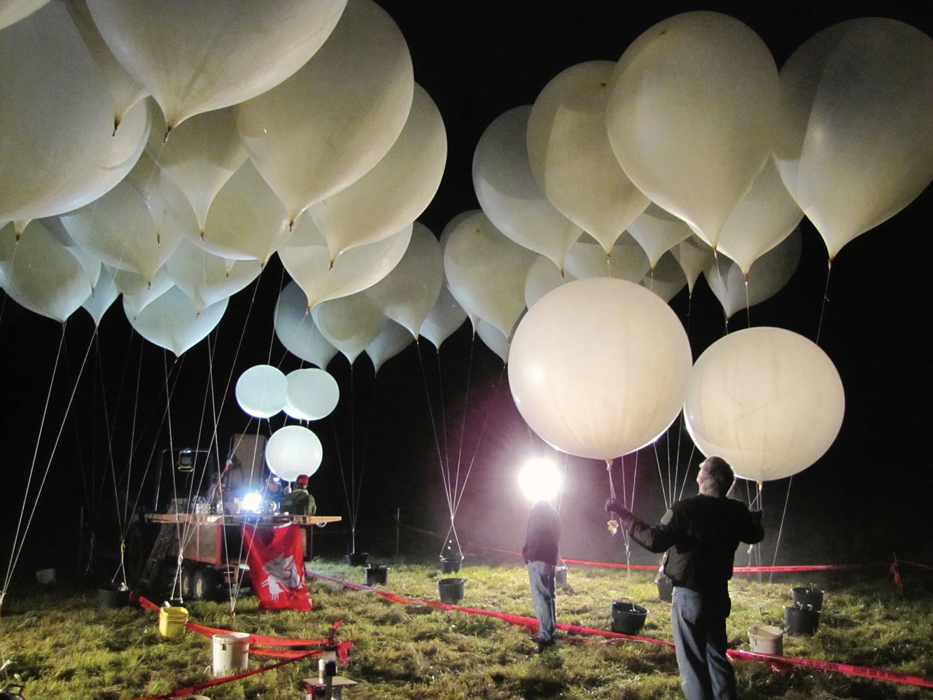 Photos by Tom Vogt/The Columbian
Team members stage clusters of balloons at the launch site before dawn Saturday.