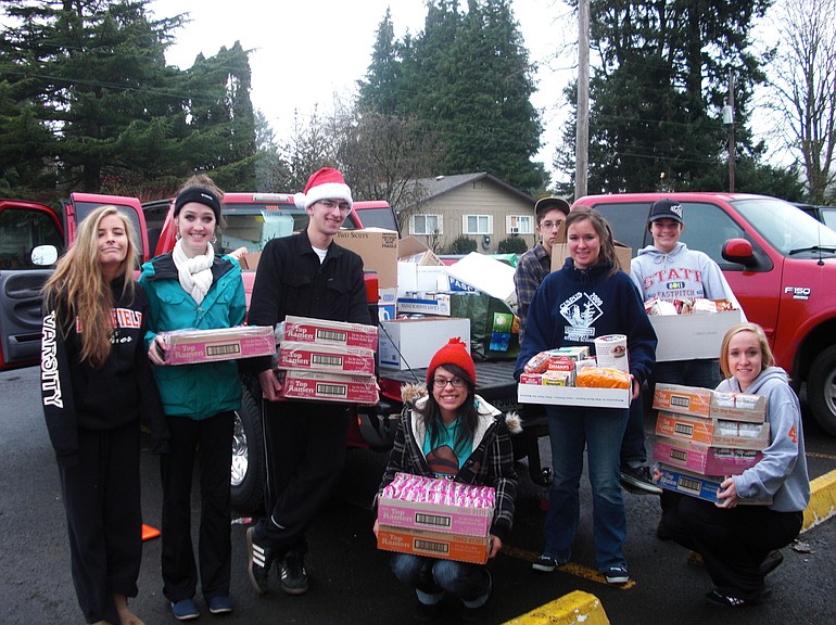 Ridgefield: Students in leadership class at Ridgefield High School help unload food collected in a food drive at the North County Community Food Bank.