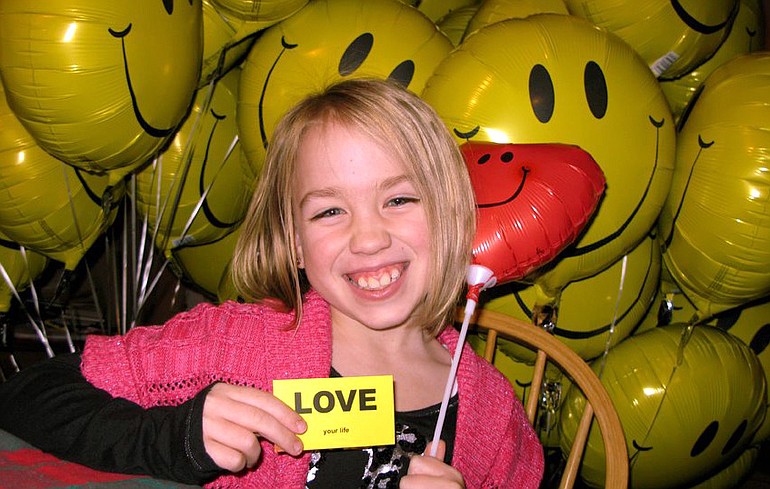 Salmon Creek: Taryn Larsen, 8, signed cards for each balloon given to patients spending Christmas at Legacy Salmon Creek Medical Center.