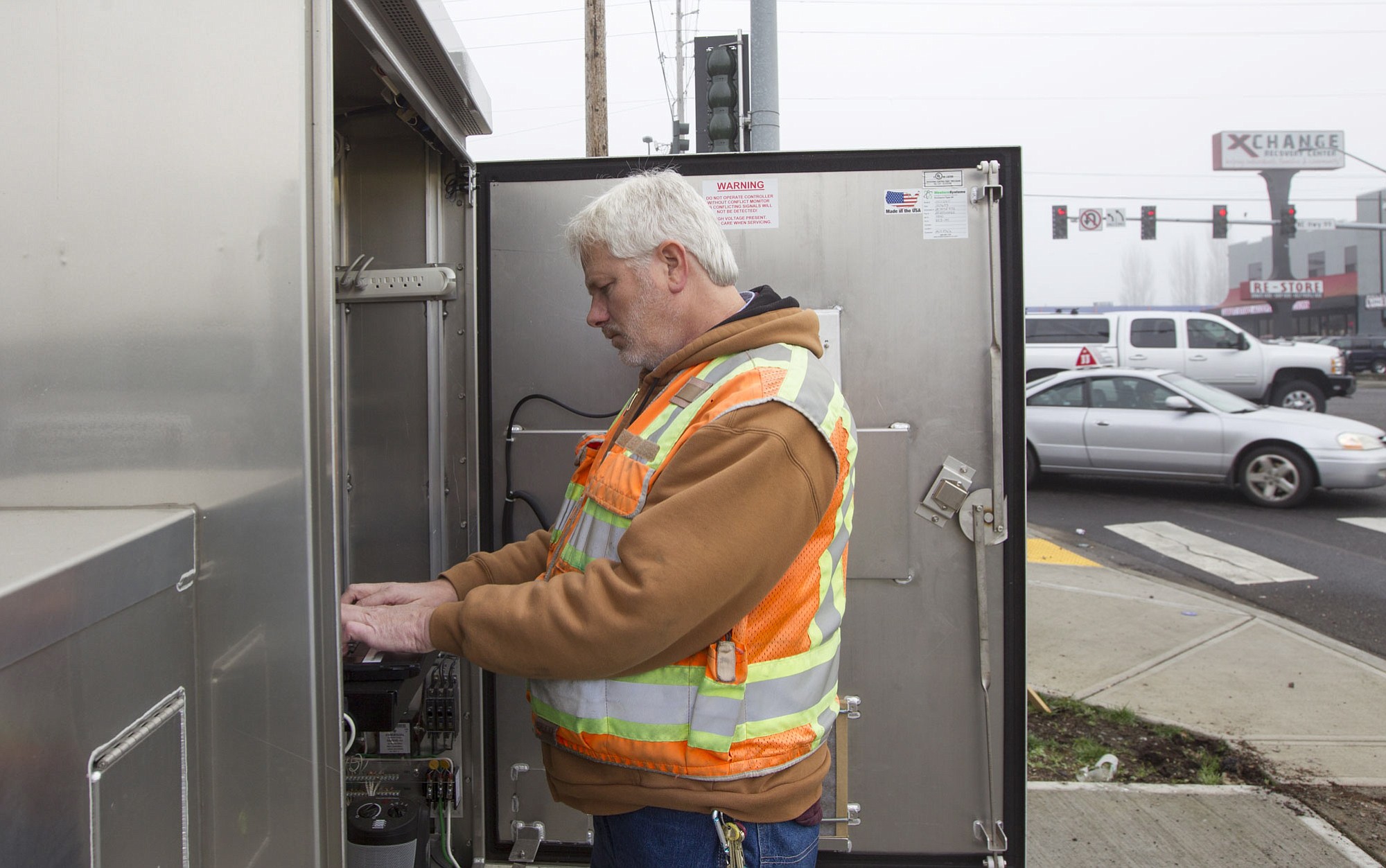 Mark Rodgers, a senior traffic signal technologist with Clark County Public Works, makes repairs at a traffic signal cabinet.