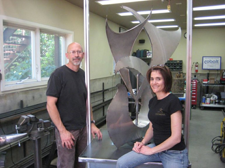 Dave Frei and Jennifer Corio of Cobalt Designworks pose next an unfinished example of their sculpture work. They will unveil a new downtown Vancouver sculpture at 7 p.m.