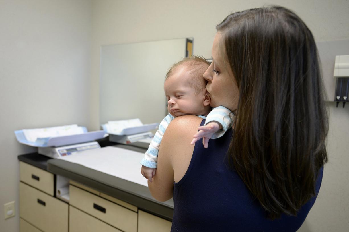 Sarah MacDonald of Camas shares a quiet moment with her 2-month-old son, River, while waiting to see Dr. Jennifer Lyons at The Vancouver Clinic Columbia Tech Center on Thursday afternoon.