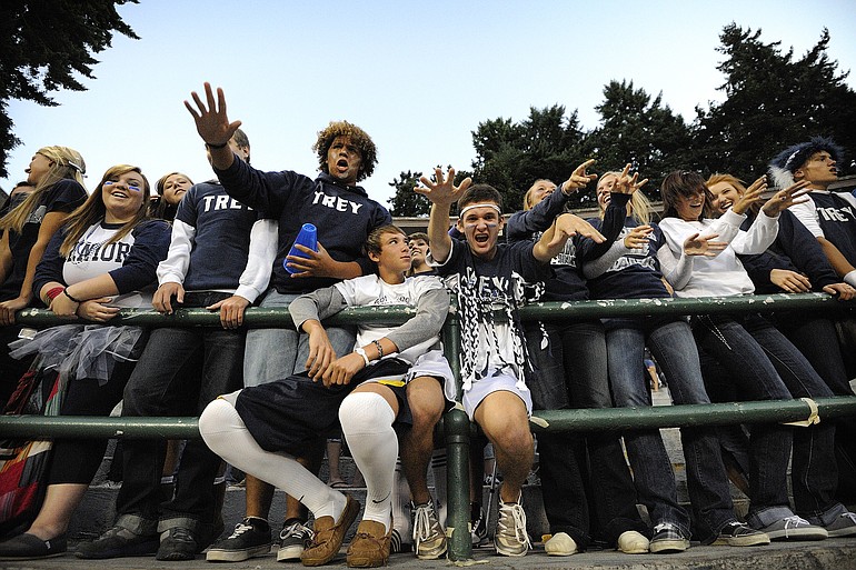 Skyview High School students, Damarcus Ball, 17, with Trey shirt on, Matt Fleischauer, 17, white sox, and Brad Usselman, 17, cheer for the home team with classmates before the start of the Skyview Sherwood High School game at Kiggins Bowl Friday in Vancouver.