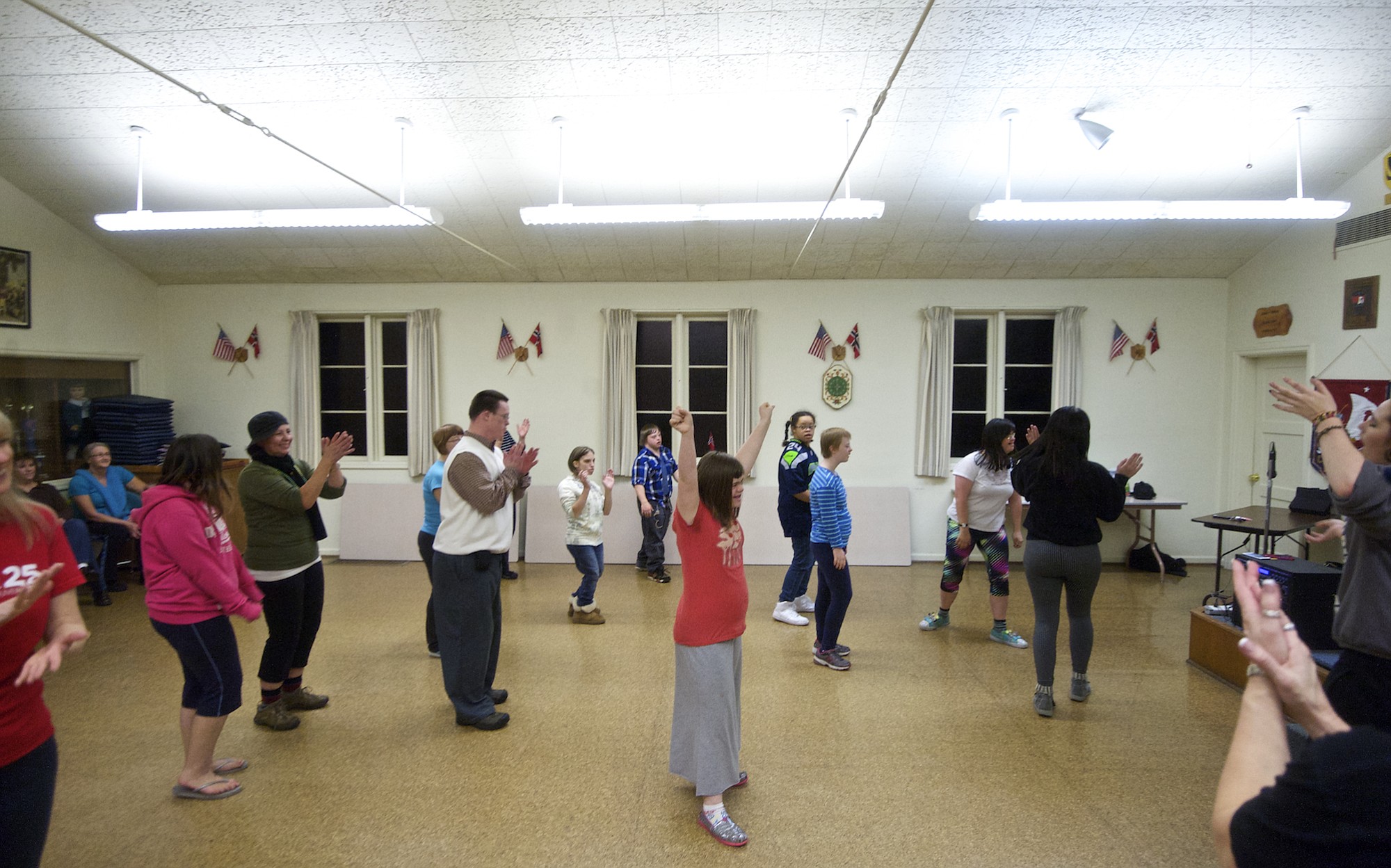 Students cheer after learning parts of a new dance routine during a hip-hop dance class geared toward people with developmental disabilities.