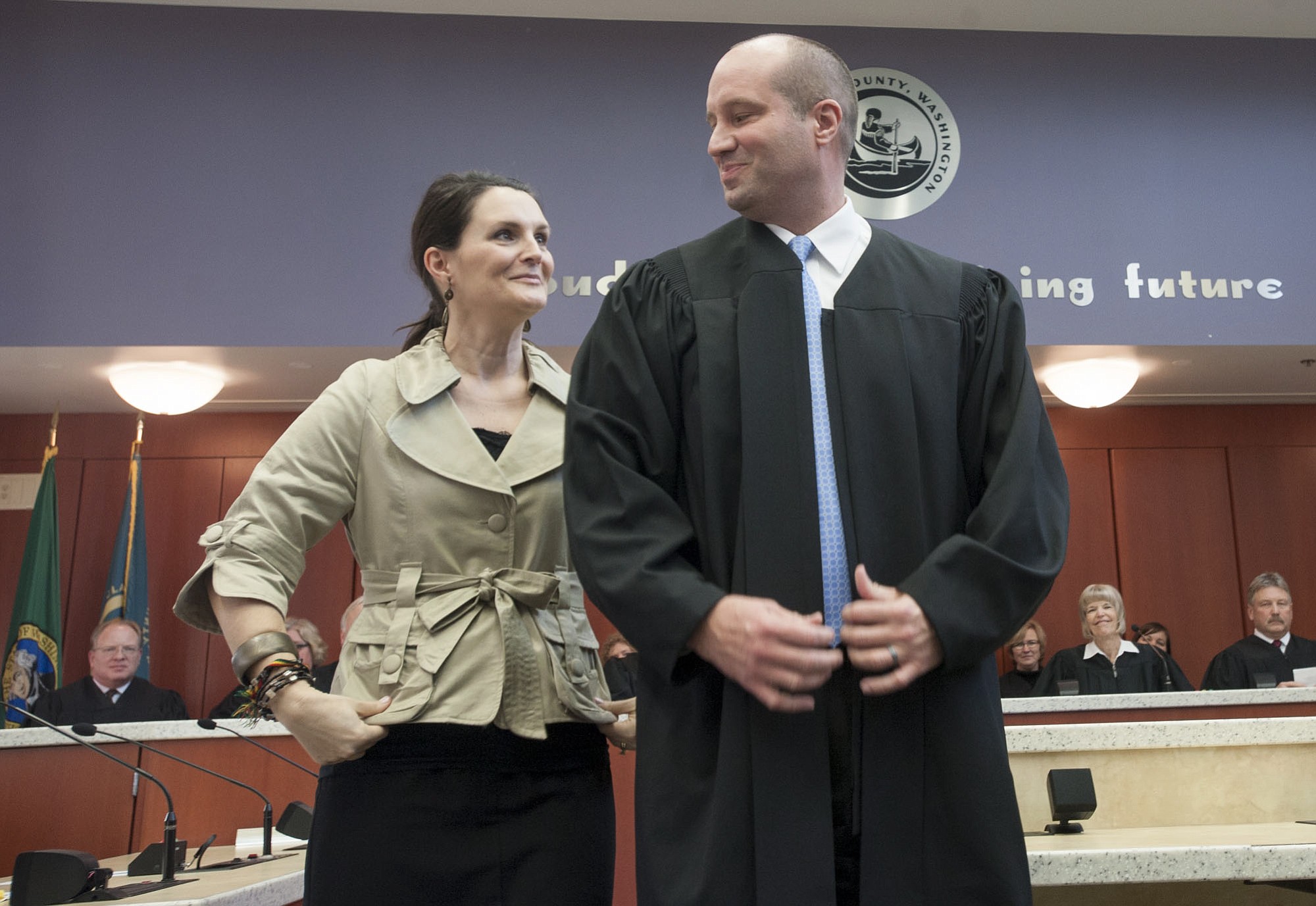 Derek Vanderwood dons a judge's robe for the first time, assisted by his wife Allison, at his swearing-in ceremony to become a judge in Clark County Superior Court.