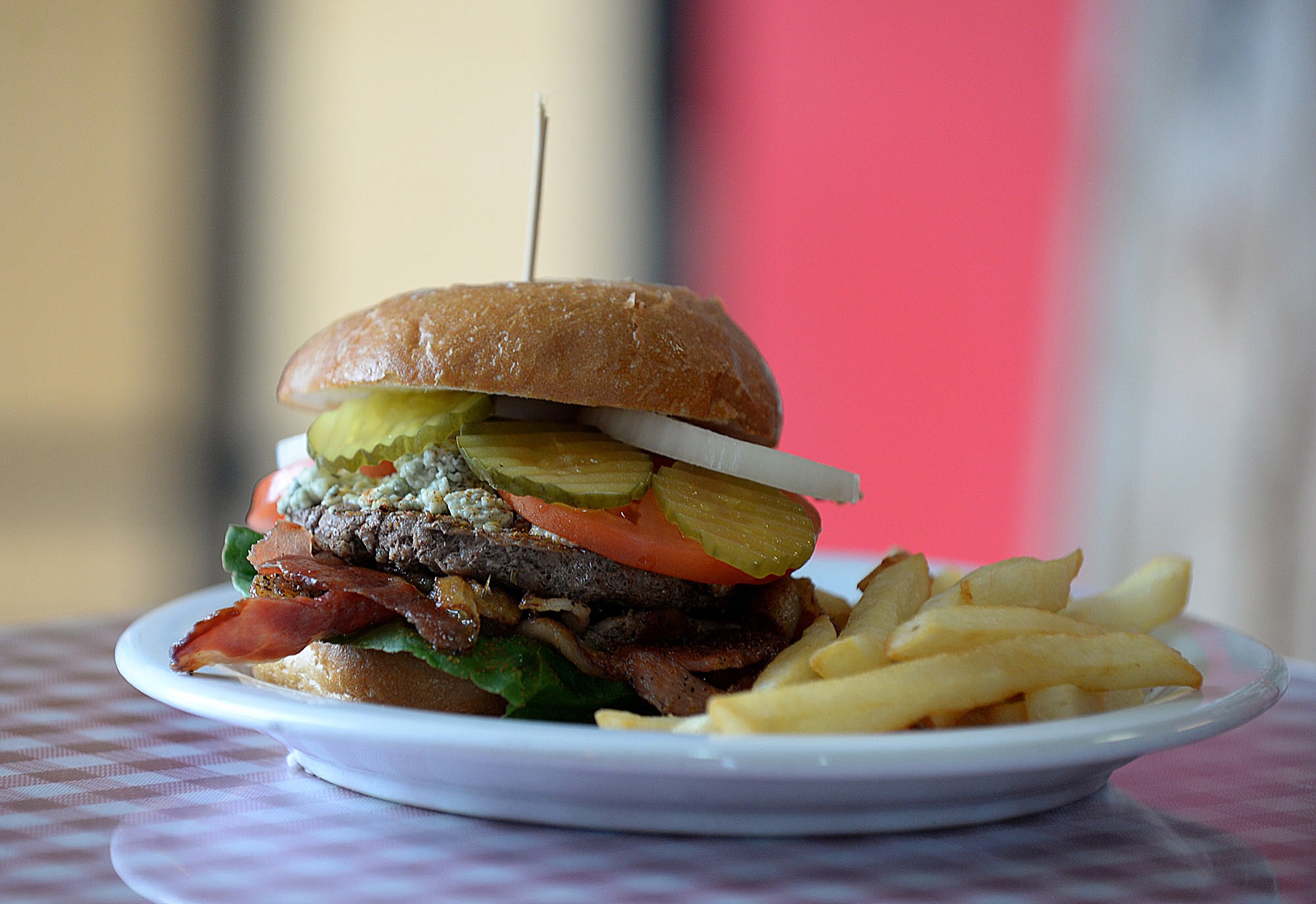 The blue cheese burger is served with fries Aug.