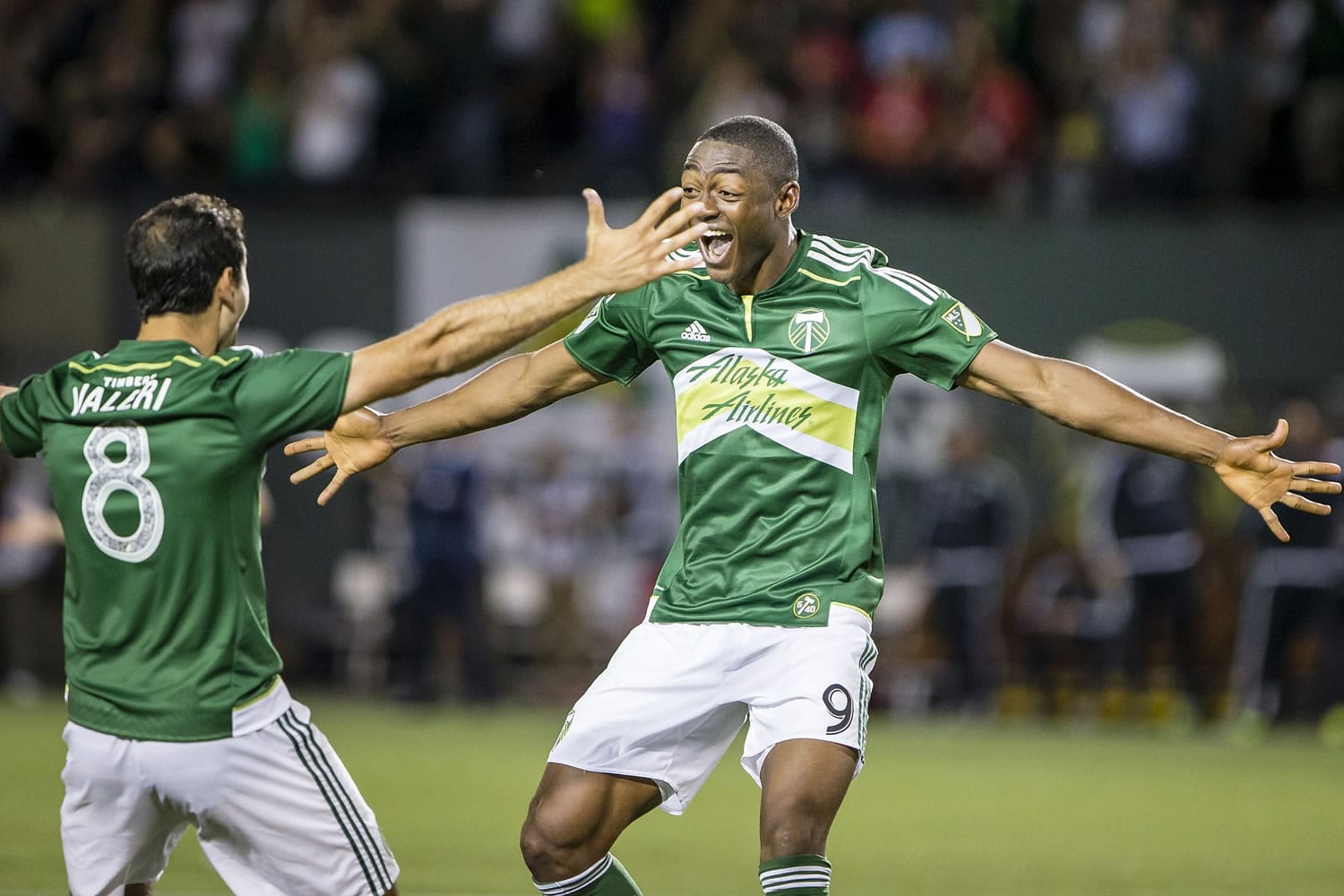 Timbers' forward Fanendo Adi, right, celebrates after scoring the first goal of the game with Diego Valeri, who assisted in the goal, during the second half at the Portland Timbers' match against the Chicago Fire on Friday Aug. 7, 2015, at Providence Park.