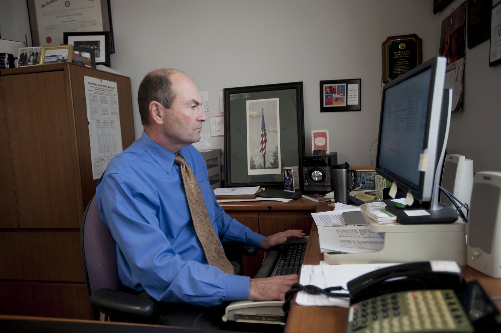 Clark County Auditor Greg Kimsey works in his office in Vancouver on Monday.