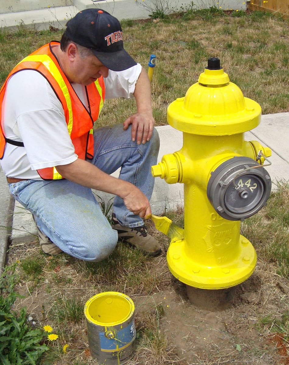 Battle Ground: Battle Ground City Council member Bill Ganley paints a fire hydrant, just as he's done with about 1,500 other hydrants in the past 12 years. He was recognized for his volunteer efforts at an Oct.