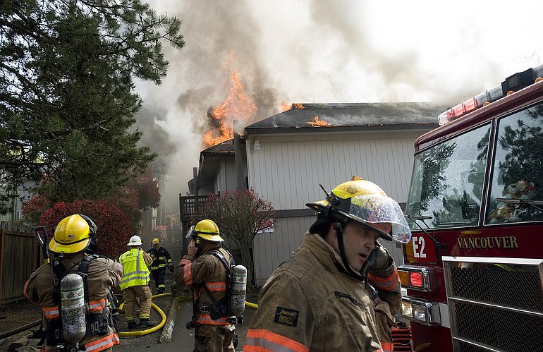 Firefighters try to contain an apartment fire at the Rolling Creek Apartments in Hazel Dell Thursday afternoon.