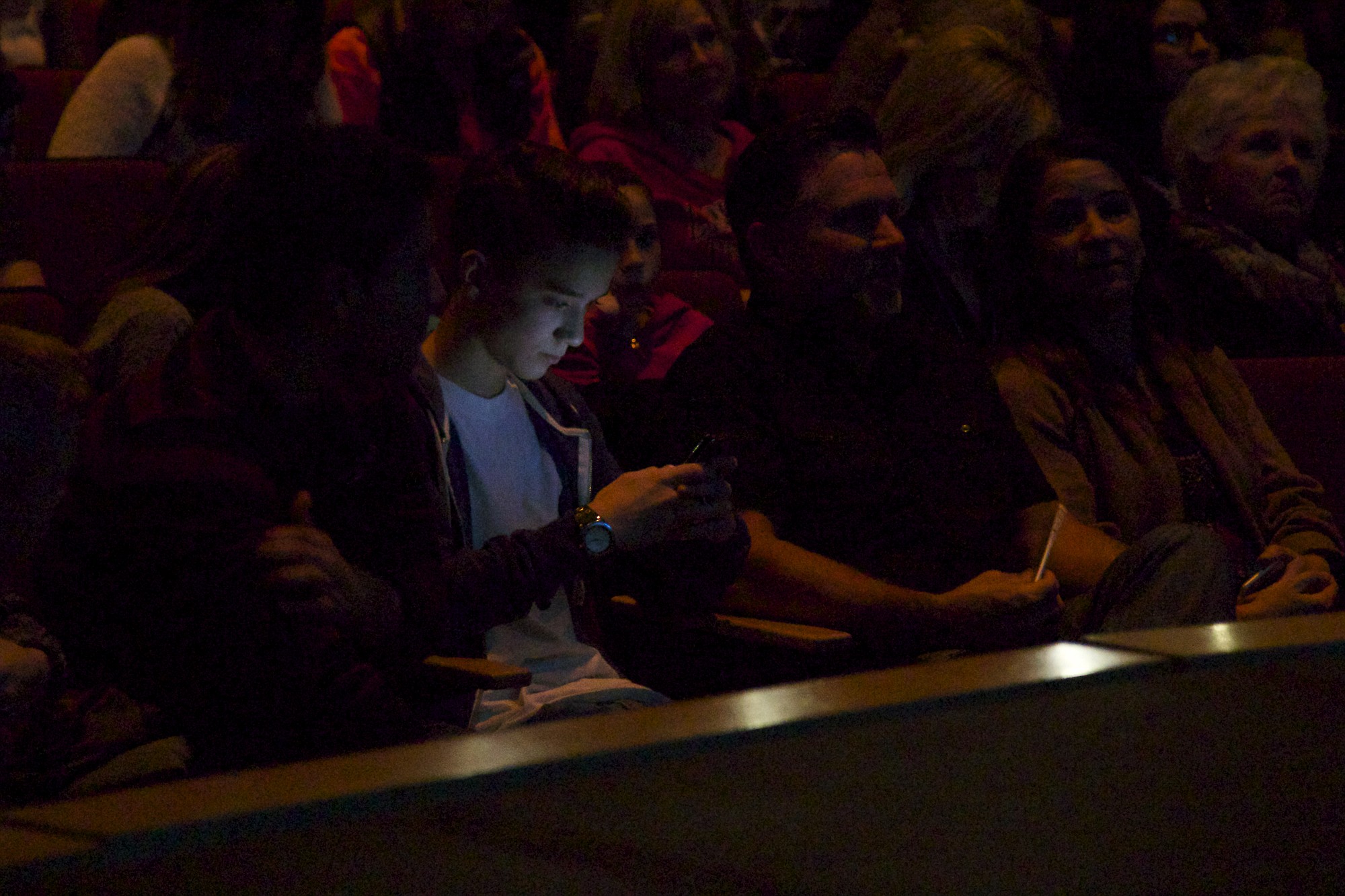 Daniel Seavey, 15, checks his phone after his screen debut on &quot;American Idol&quot; during a screening at Union High School.
