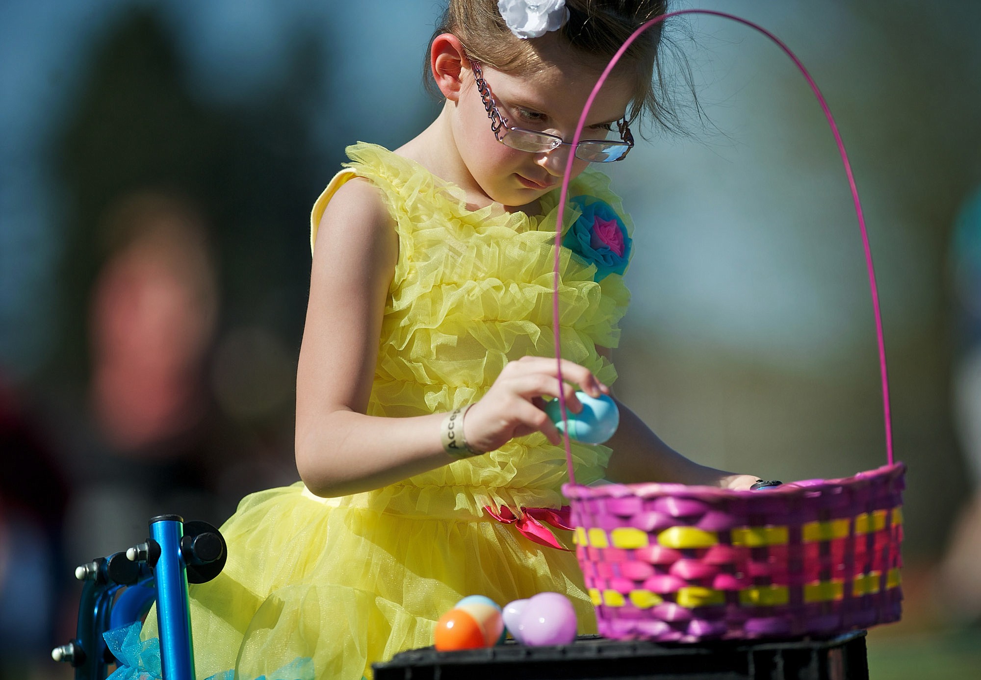 Olivia Hughes, 5, carefully plucks an Easter egg placed on stacked milk cartons.