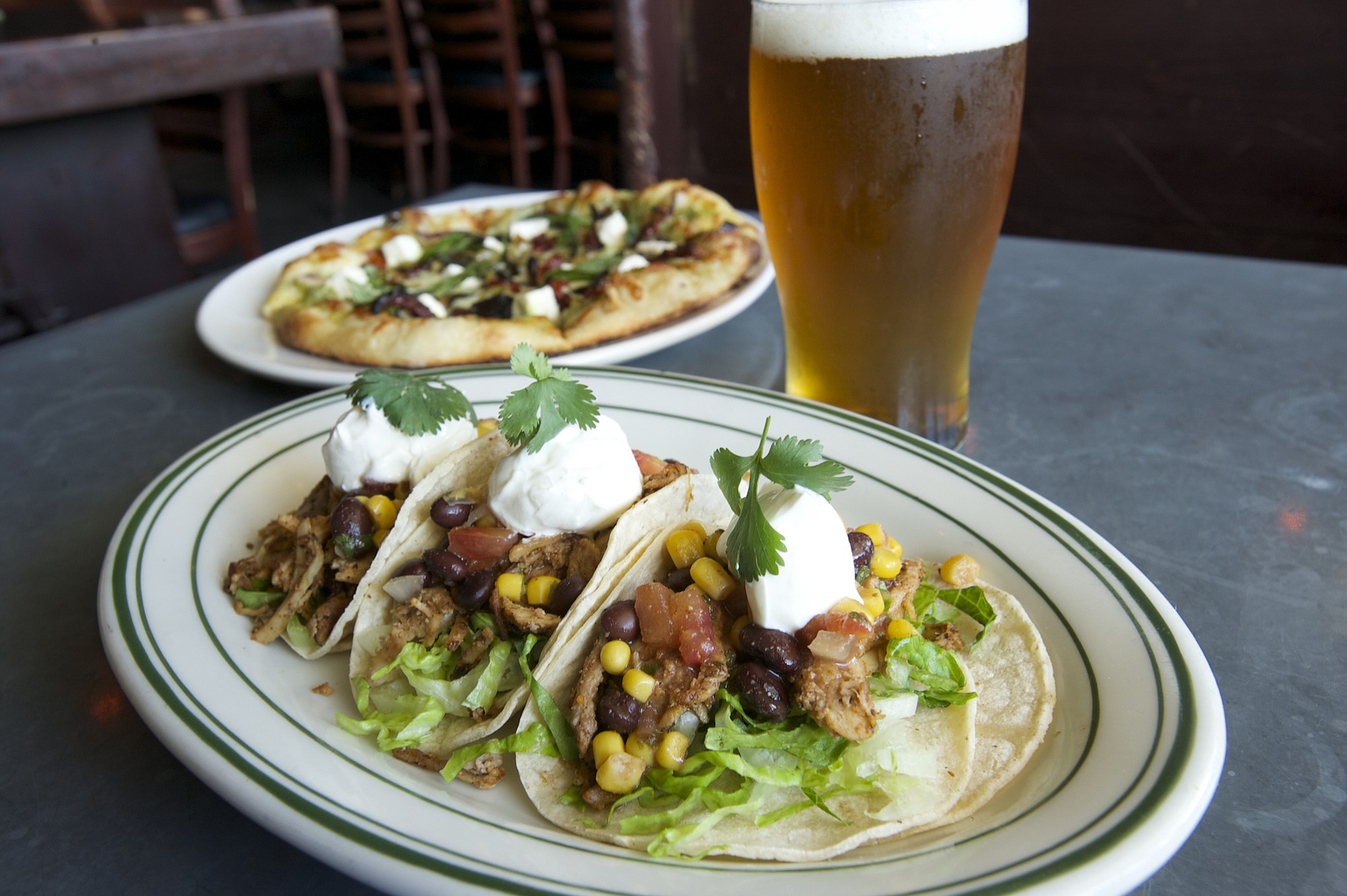 Pork carnitas tacos and the Electric Mayhem pizza are served June 9 at McMenamins East Vancouver.