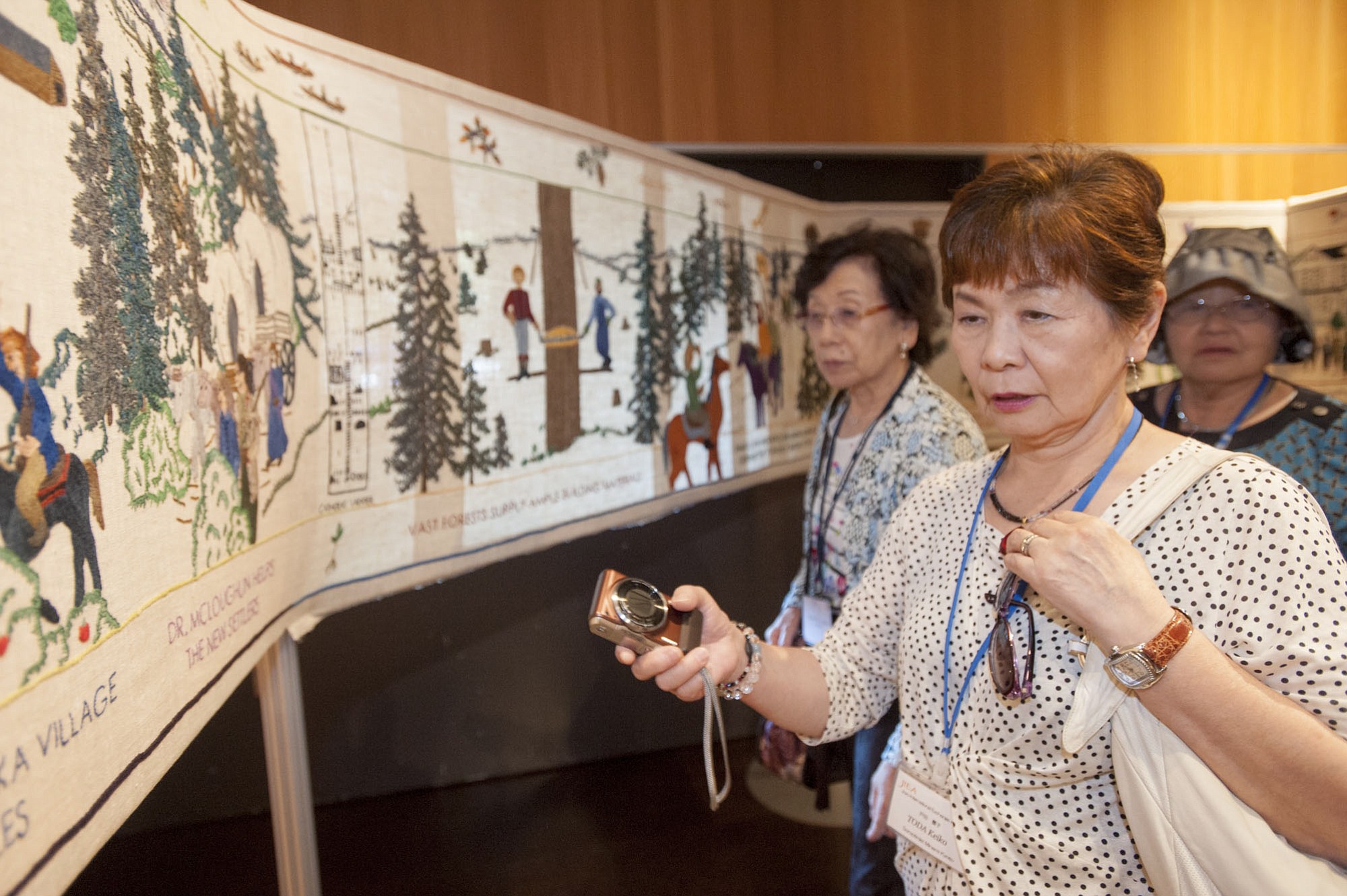Keiko Toda examines a portion of the Fort Vancouver Tapestry that she helped stitch, which shows the history of Clark County.