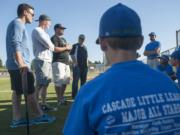 From left, former Hazel Dell Little League baseball players Jay Ponciano, Jackson Evans, Union High School coach Ben McGrew and former Hazel Dell coach Jim Ponciano give the Cascade Little League players advice prior to practice in Vancouver on Tuesday August 4, 2015.