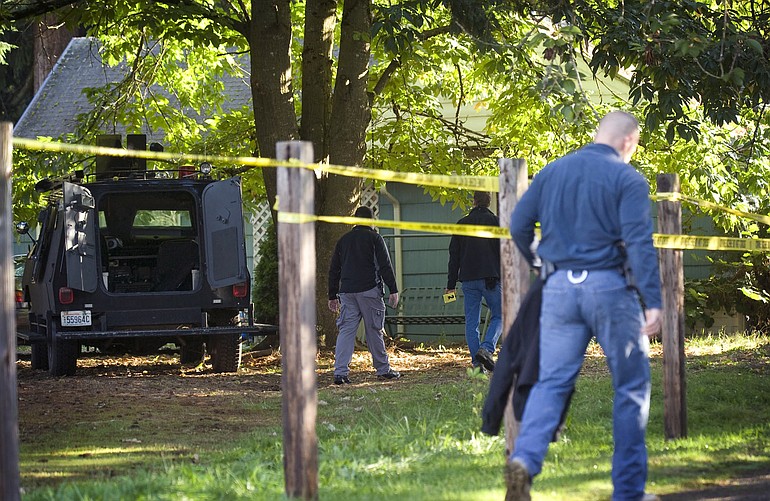 Law enforcement officials continued their investigation Wednesday morning at a house in the 3900 block of Northeast 62nd Street in Vancouver where a woman was shot and a man killed, late Tuesday night.
