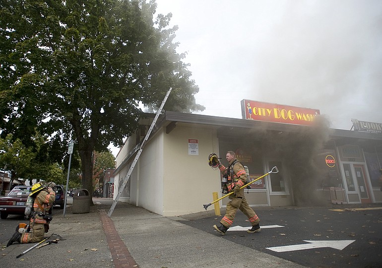 Firefighters respond to a structure fire at the Schofield's Corner shopping center on Thursday.