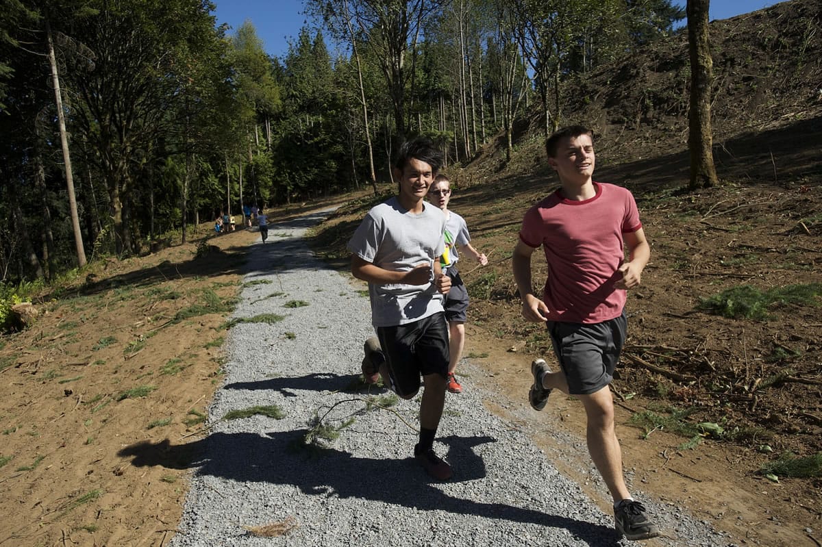 The Evergreen High School's cross country team's home race course includes a new gravel path that goes through a wooded area behind the school.