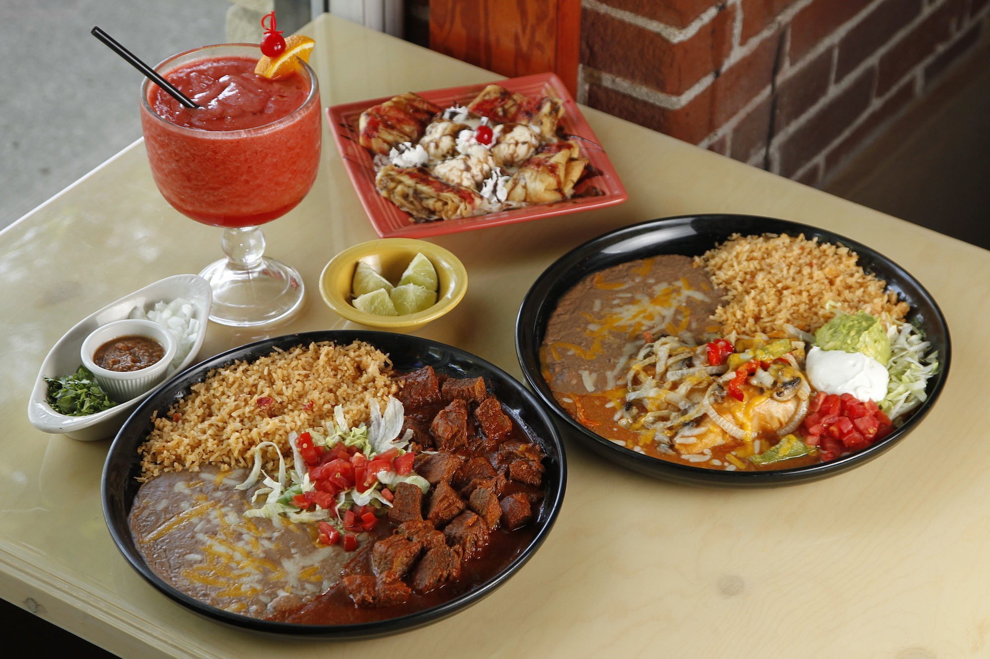 Chile colorado, left, enchiladas rancheras and banana chimi for dessert at Jorge's Tequila Factory.