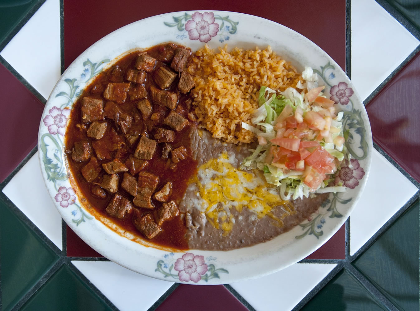 Chile Colorado -- made with cubes of top sirloin in a traditional sauce-- is served with rice and beans at Catedral Tapatia in Vancouver.