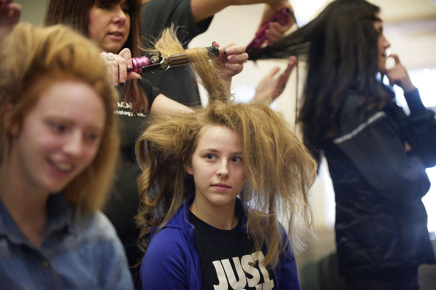 Bethany Lowery, 18, has her hair done by Val Taylor before the start of a Columbia River High School fashion show fundraiser at Thomas Jefferson Middle School, Sunday, February 10, 2013.