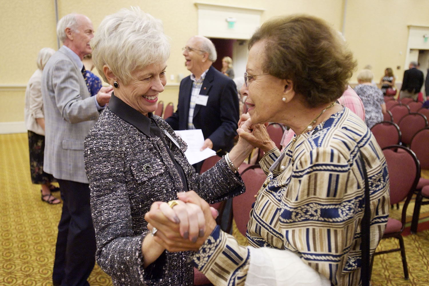 Photos by Steven Lane/The Columbian
Clark County First Citizen for 2014 Twyla Barnes, left, greets Maria Bigelow after her award ceremony at the Hilton Vancouver Washington on Tuesday. Barnes was noted for big-picture leadership while making every person she worked with feel special.