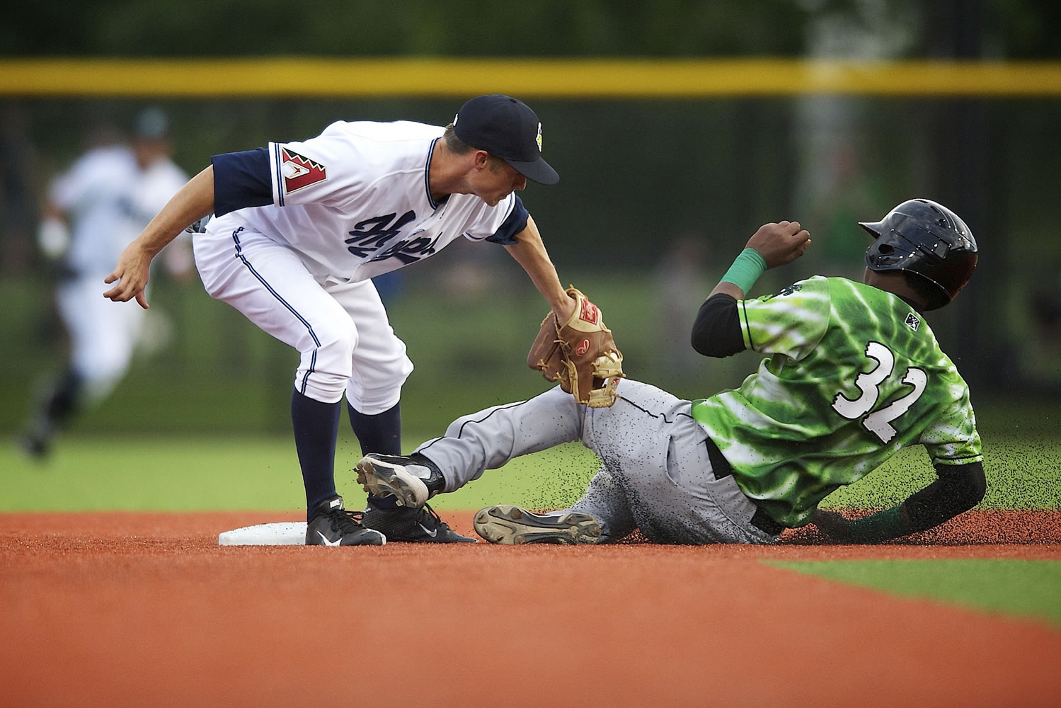 Josh Parr, left, of the Hillsboro Hops tags out Henry Charles of the Eugene Emeralds at second base in the bottom of the third inning Monday at the new Hillsboro Ballpark.